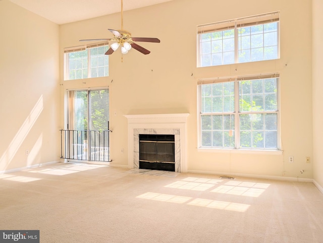7805 Chartwell Pl, Greenbelt, MD 20770 - unfurnished living room featuring a high ceiling, carpet floors, a ceiling fan, a premium fireplace, and healthy amount of natural light