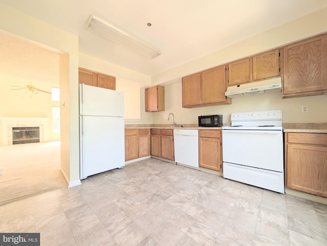 7805 Chartwell Pl, Greenbelt, MD 20770 - kitchen with white appliances, under cabinet range hood, light countertops, and a glass covered fireplace