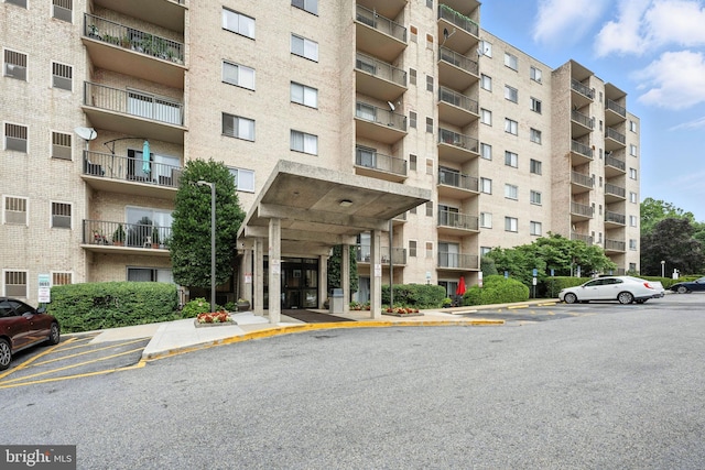12001 Old Columbia Pike Unit 305, Silver Spring, MD 20904 - view of apartment building / complex featuring uncovered parking
