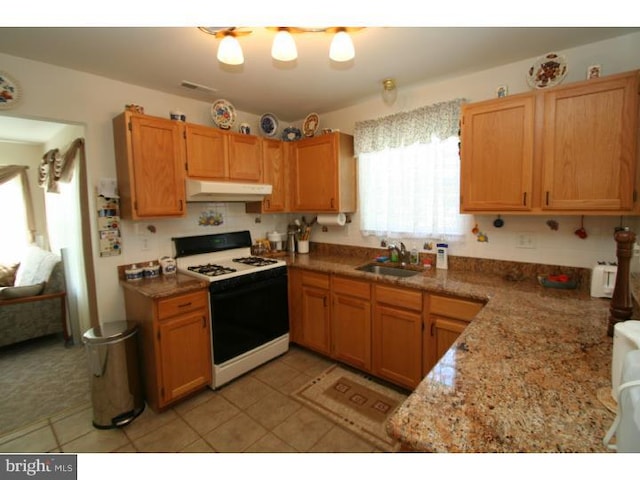 5 Vaccaro Rd, Lawrenceville, NJ 08648 - kitchen featuring white range with gas cooktop, under cabinet range hood, and light tile patterned floors