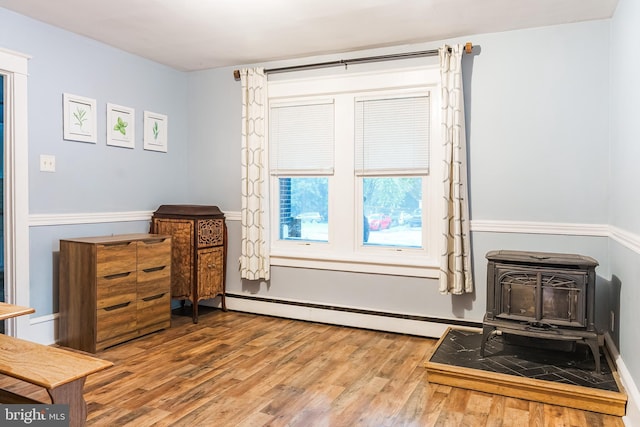850 N Reading Ave, Boyertown, PA 19512 - bedroom featuring a wood stove, wood finished floors, and baseboard heating