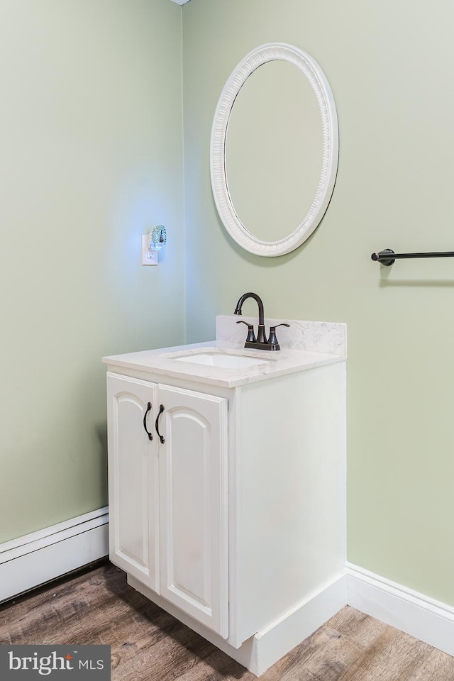 850 N Reading Ave, Boyertown, PA 19512 - bathroom featuring a baseboard radiator, wood finished floors, and vanity