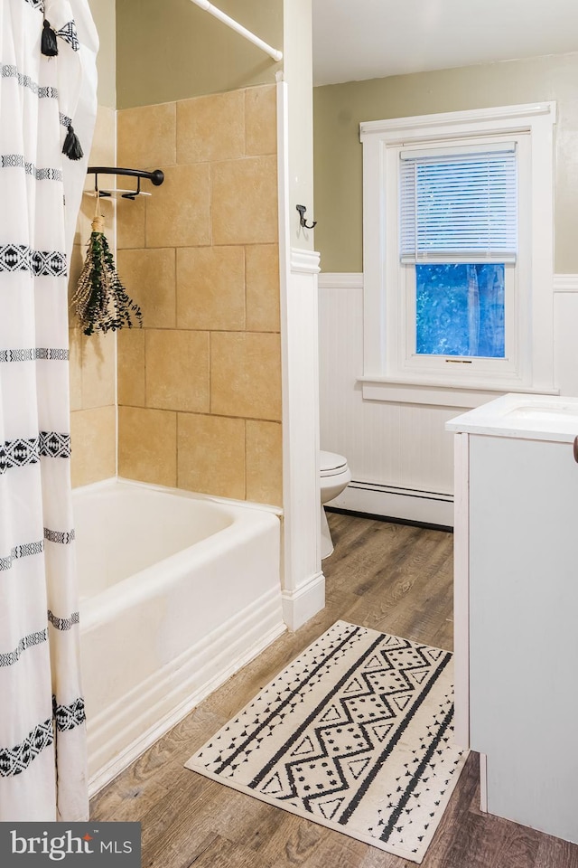 850 N Reading Ave, Boyertown, PA 19512 - full bath with wood finished floors, shower / tub combo with curtain, a wainscoted wall, baseboard heating, and vanity