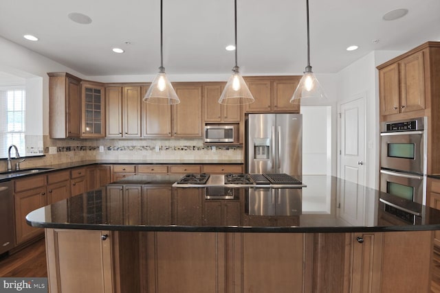 13319 Moonlight Trail Dr, Silver Spring, MD 20906 - kitchen with stainless steel appliances, a spacious island, backsplash, glass insert cabinets, and dark stone counters
