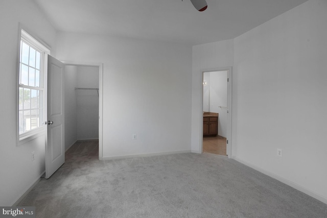 13319 Moonlight Trail Dr, Silver Spring, MD 20906 - unfurnished bedroom with multiple windows, carpet flooring, a spacious closet, and connected bathroom