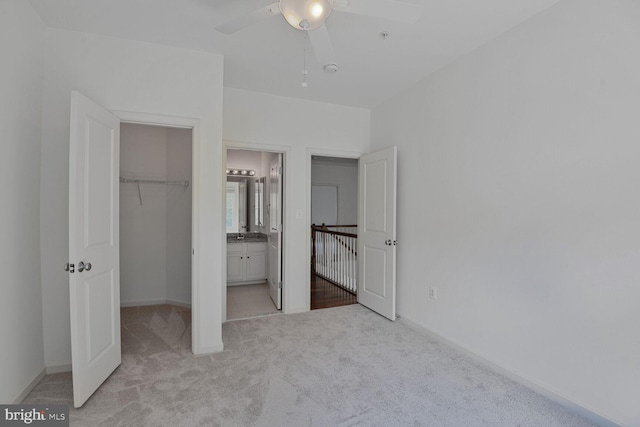 13319 Moonlight Trail Dr, Silver Spring, MD 20906 - unfurnished bedroom with light carpet, a walk in closet, a closet, ensuite bath, and a ceiling fan