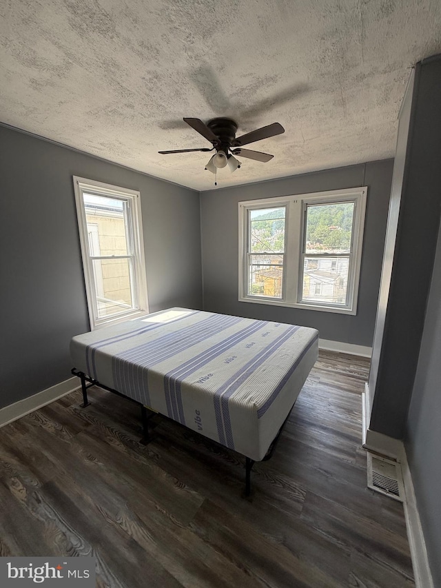 1631 Cotton St, Reading, PA 19606 - bedroom featuring a textured ceiling, dark wood-type flooring, and ceiling fan