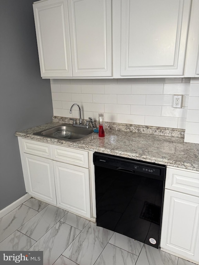 1631 Cotton St, Reading, PA 19606 - kitchen featuring black dishwasher, white cabinetry, light marble finish floors, and tasteful backsplash