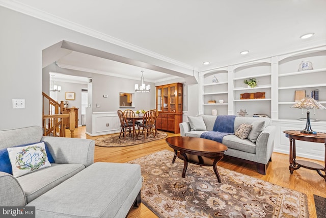 913 Rolfe Pl, Alexandria, VA 22314 - living area with a chandelier, crown molding, light wood-type flooring, wainscoting, and built in features