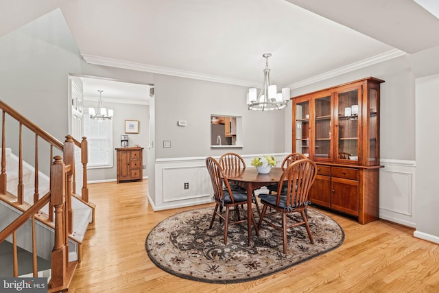 913 Rolfe Pl, Alexandria, VA 22314 - dining space with a chandelier, light wood finished floors, stairs, ornamental molding, and a wainscoted wall