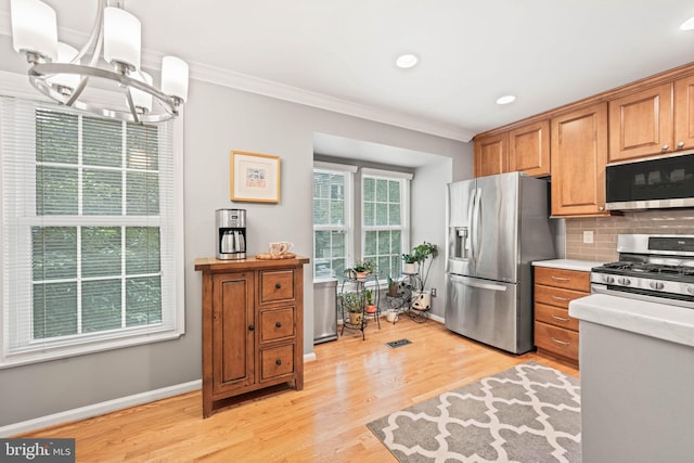 913 Rolfe Pl, Alexandria, VA 22314 - kitchen with stainless steel appliances, crown molding, plenty of natural light, a chandelier, and backsplash