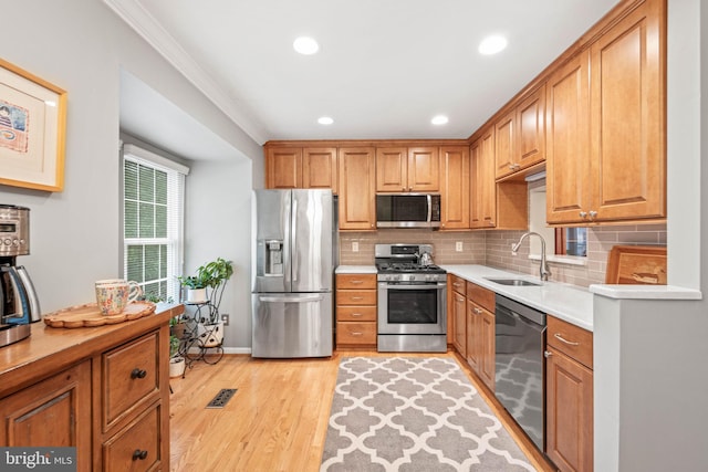 913 Rolfe Pl, Alexandria, VA 22314 - kitchen with stainless steel appliances, backsplash, light wood-style floors, recessed lighting, and light countertops
