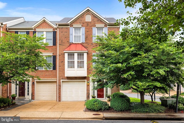 913 Rolfe Pl, Alexandria, VA 22314 - townhome / multi-family property featuring concrete driveway, a garage, and brick siding