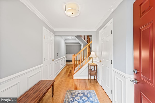 913 Rolfe Pl, Alexandria, VA 22314 - entryway with a decorative wall, ornamental molding, light wood-type flooring, stairs, and a wainscoted wall