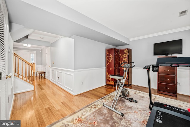 913 Rolfe Pl, Alexandria, VA 22314 - workout room with crown molding, wood finished floors, and a wainscoted wall