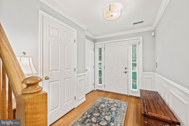 913 Rolfe Pl, Alexandria, VA 22314 - foyer entrance with light wood-style floors, ornamental molding, a wainscoted wall, and a decorative wall