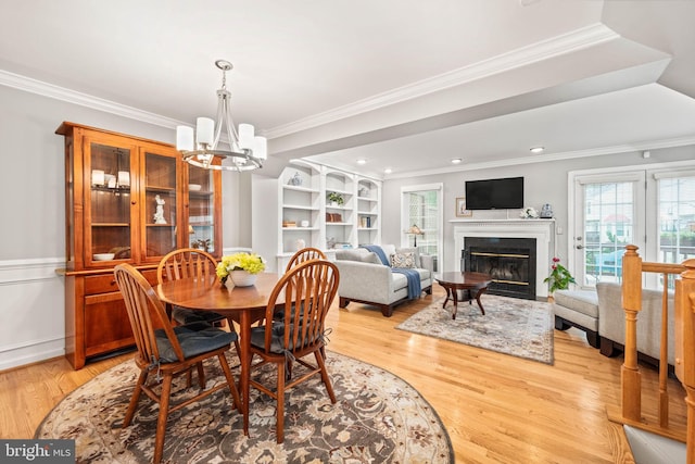 913 Rolfe Pl, Alexandria, VA 22314 - dining space featuring a chandelier, plenty of natural light, ornamental molding, light wood finished floors, and wainscoting