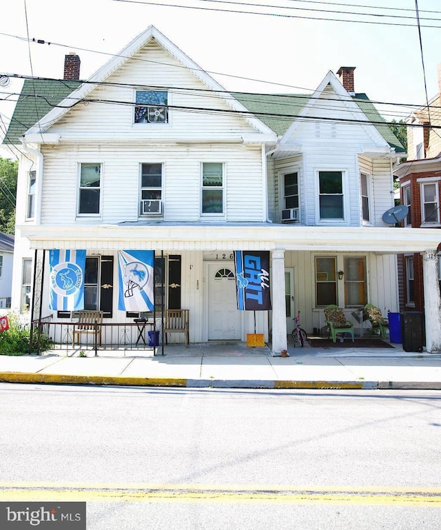 126 W Main St, Windsor, PA 17366 - townhome / multi-family property with a porch, a chimney, board and batten siding, and cooling unit