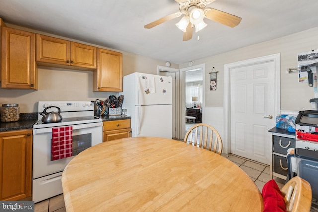 138 Morgan Ave, Hamilton, NJ 08619 - kitchen featuring white appliances, light tile patterned flooring, a ceiling fan, brown cabinetry, and wainscoting