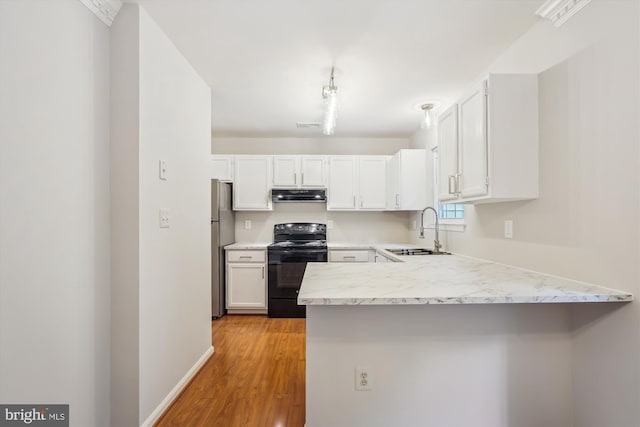 10 Suncroft Ct, Silver Spring, MD 20904 - kitchen featuring electric range, under cabinet range hood, a peninsula, white cabinetry, and light wood-type flooring