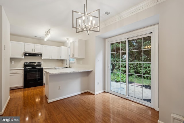 10 Suncroft Ct, Silver Spring, MD 20904 - kitchen featuring black electric range, under cabinet range hood, white cabinetry, wood finished floors, and a chandelier