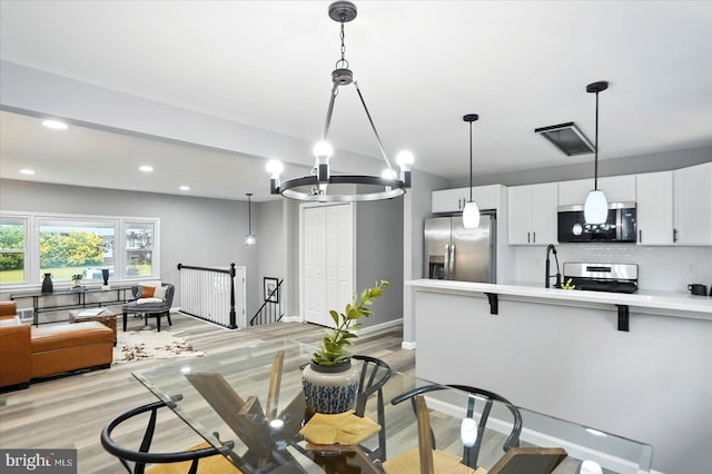 1415 Larch Rd, Severn, MD 21144 - dining room with light wood-style flooring, recessed lighting, and a chandelier