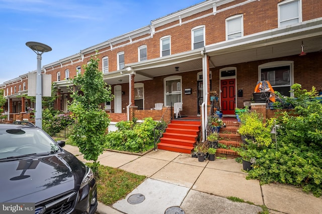 619 E 36th St E, Baltimore, MD 21218 - view of property with brick siding and covered porch