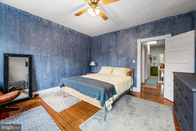 619 E 36th St E, Baltimore, MD 21218 - bedroom with wood finished floors, a ceiling fan, and radiator heating unit