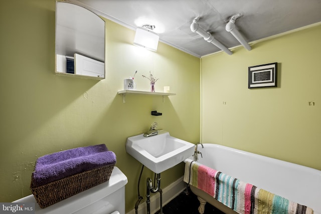 619 E 36th St E, Baltimore, MD 21218 - bathroom featuring a soaking tub and toilet