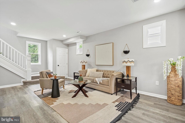 3912 Fernhill Ave, Baltimore, MD 21215 - living room featuring light wood-type flooring, stairs, healthy amount of natural light, and recessed lighting