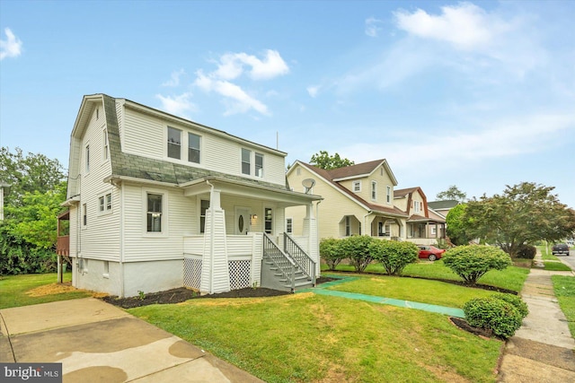 3912 Fernhill Ave, Baltimore, MD 21215 - view of front of house featuring a porch, a front yard, and a gambrel roof