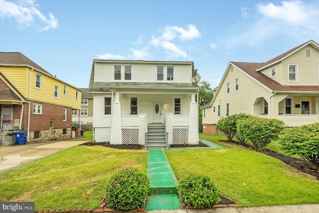 3912 Fernhill Ave, Baltimore, MD 21215 - view of front of property featuring a front yard, a porch, and driveway