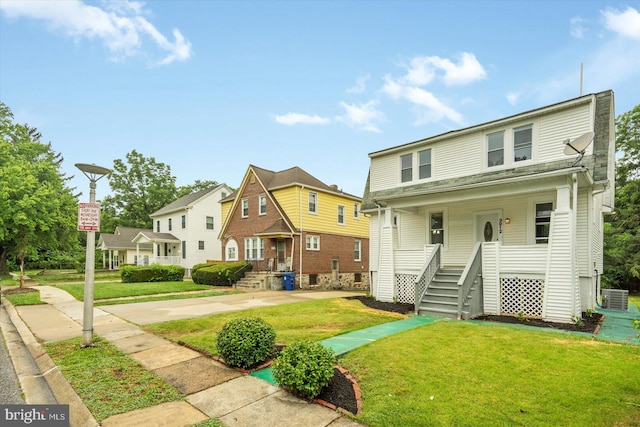 3912 Fernhill Ave, Baltimore, MD 21215 - view of front of home with a front yard, a porch, and a residential view
