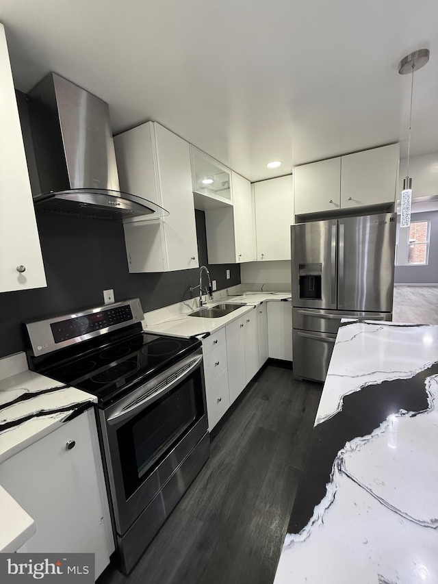 331 Spring Garden St, Reading, PA 19602 - kitchen featuring wall chimney exhaust hood, stainless steel appliances, white cabinets, dark wood-type flooring, and decorative light fixtures