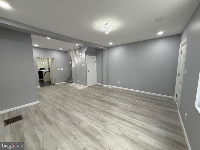 331 Spring Garden St, Reading, PA 19602 - unfurnished living room featuring recessed lighting, light wood-type flooring, and stairway