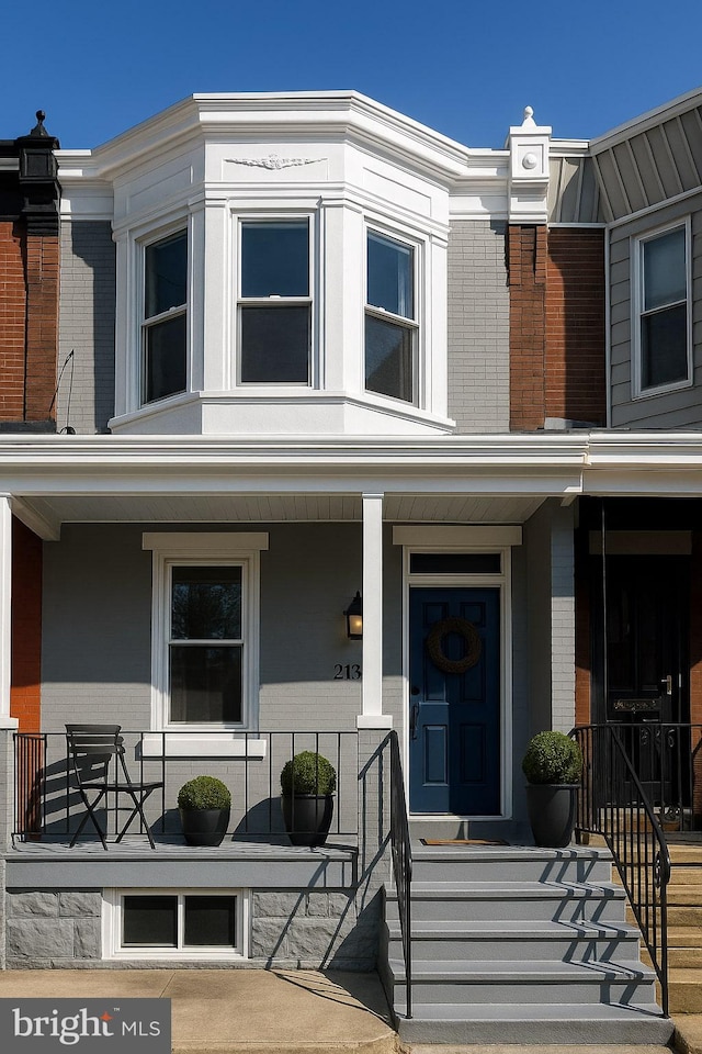 335 N 60th St, Philadelphia, PA 19139 - view of front facade featuring brick siding and a porch