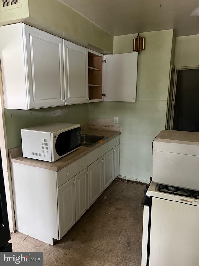 1002 Agnew Dr Unit 1, Drexel Hill, PA 19026 - kitchen featuring white appliances, white cabinetry, and open shelves