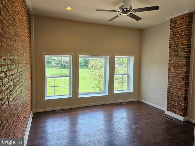 1427 E Eager St, Baltimore, MD 21205 - spare room with plenty of natural light, dark wood-style floors, ceiling fan, and brick wall