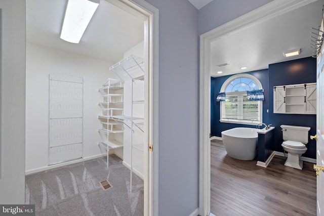 20 Bee Tree Mill Ct, Parkton, MD 21120 - bathroom featuring a soaking tub and wood finished floors
