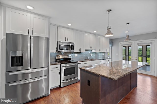 20 Bee Tree Mill Ct, Parkton, MD 21120 - kitchen featuring appliances with stainless steel finishes, french doors, a center island, white cabinets, and tasteful backsplash