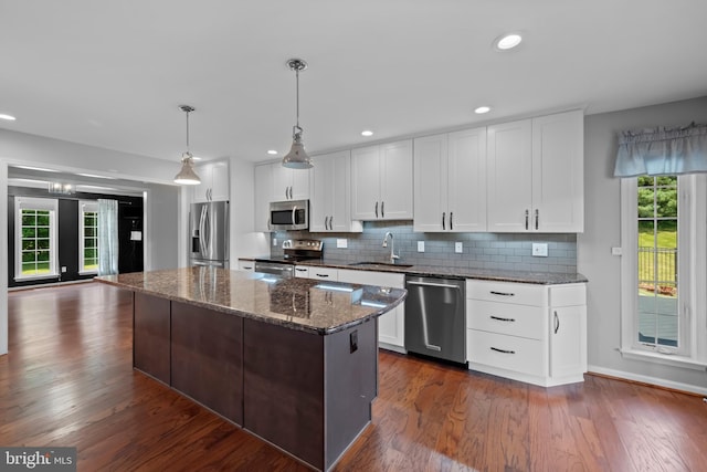 20 Bee Tree Mill Ct, Parkton, MD 21120 - kitchen with stainless steel appliances, a kitchen island, decorative backsplash, white cabinetry, and dark wood finished floors