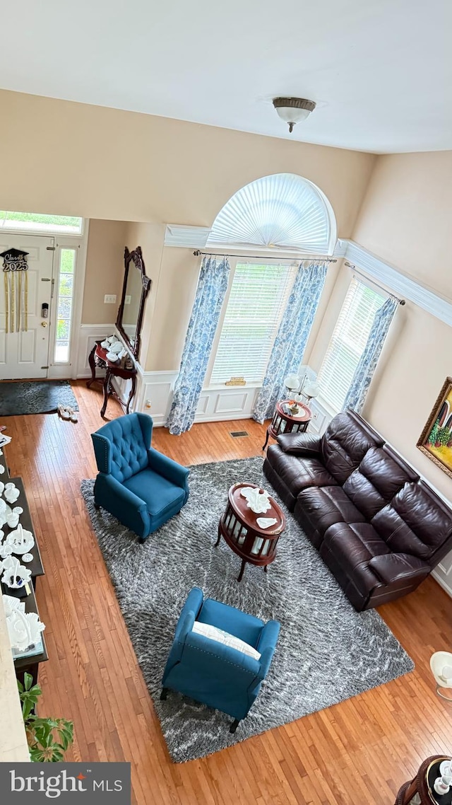217 Smarty Jones Ter, Havre De Grace, MD 21078 - living room with wood-type flooring, wainscoting, and a decorative wall