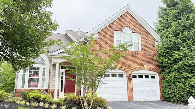217 Smarty Jones Ter, Havre De Grace, MD 21078 - view of front of house with brick siding, driveway, an attached garage, and roof with shingles