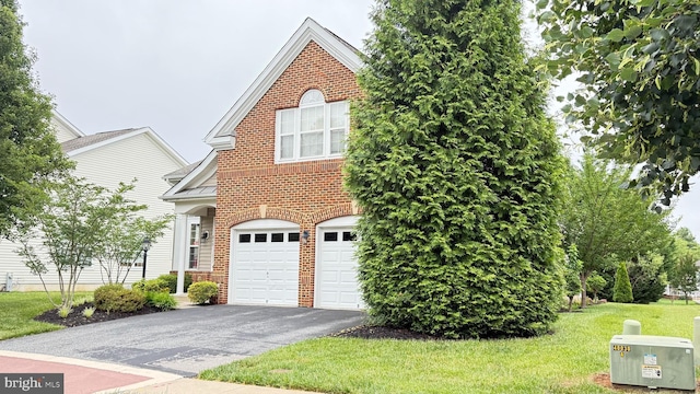 217 Smarty Jones Ter, Havre De Grace, MD 21078 - view of front of home with brick siding, driveway, an attached garage, and a front yard