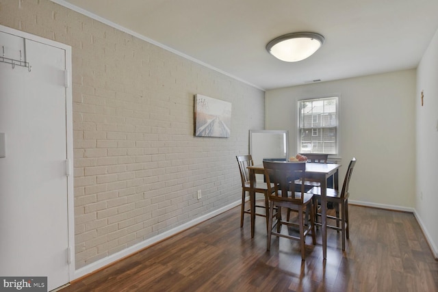 784 Quince Orchard Blvd Unit T1, Gaithersburg, MD 20878 - dining space featuring brick wall, wood finished floors, and ornamental molding