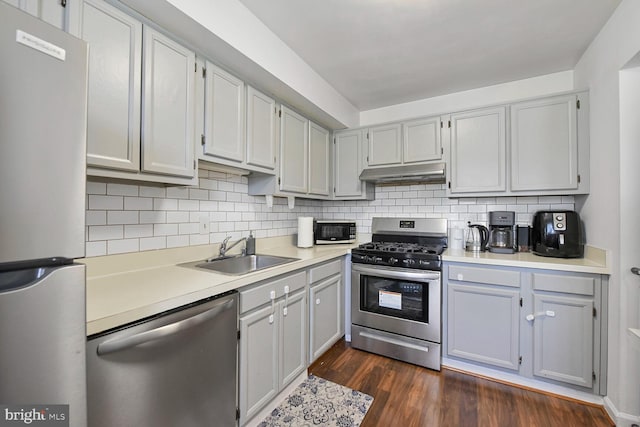 784 Quince Orchard Blvd Unit T1, Gaithersburg, MD 20878 - kitchen with stainless steel appliances, under cabinet range hood, backsplash, dark wood-style floors, and light countertops