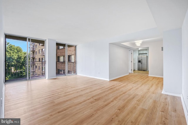 1836 Metzerott Rd Unit 419, Hyattsville, MD 20783 - unfurnished living room featuring light wood-type flooring, floor to ceiling windows, and a chandelier