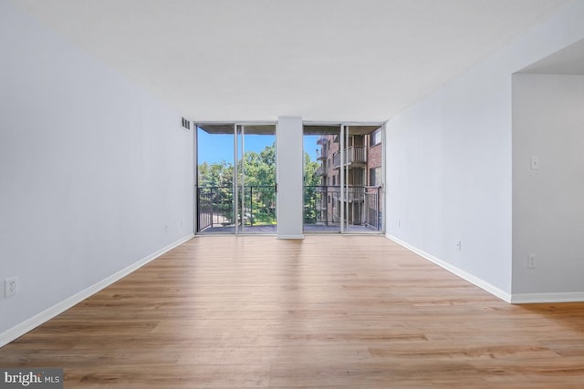 1836 Metzerott Rd Unit 419, Hyattsville, MD 20783 - unfurnished room featuring wood finished floors and floor to ceiling windows
