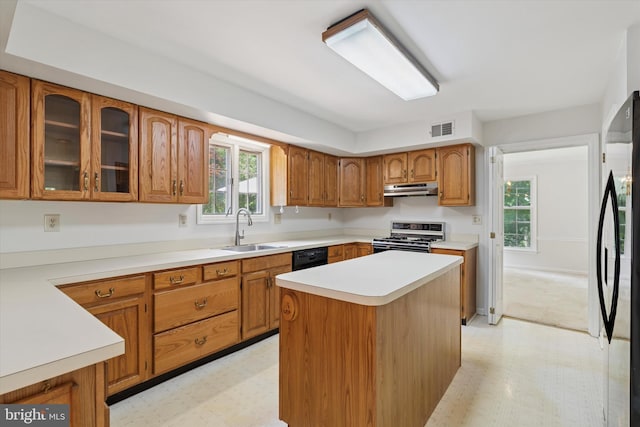213 Willits Way, Glen Mills, PA 19342 - kitchen with white range with gas stovetop, under cabinet range hood, freestanding refrigerator, and light floors