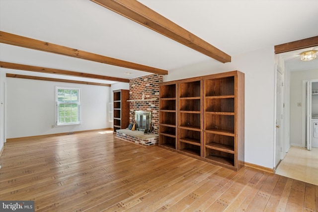 213 Willits Way, Glen Mills, PA 19342 - unfurnished living room featuring hardwood / wood-style floors, beamed ceiling, and a brick fireplace